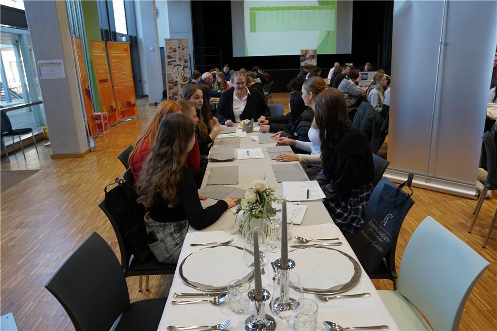 Schüler sitzen an einem Tisch.