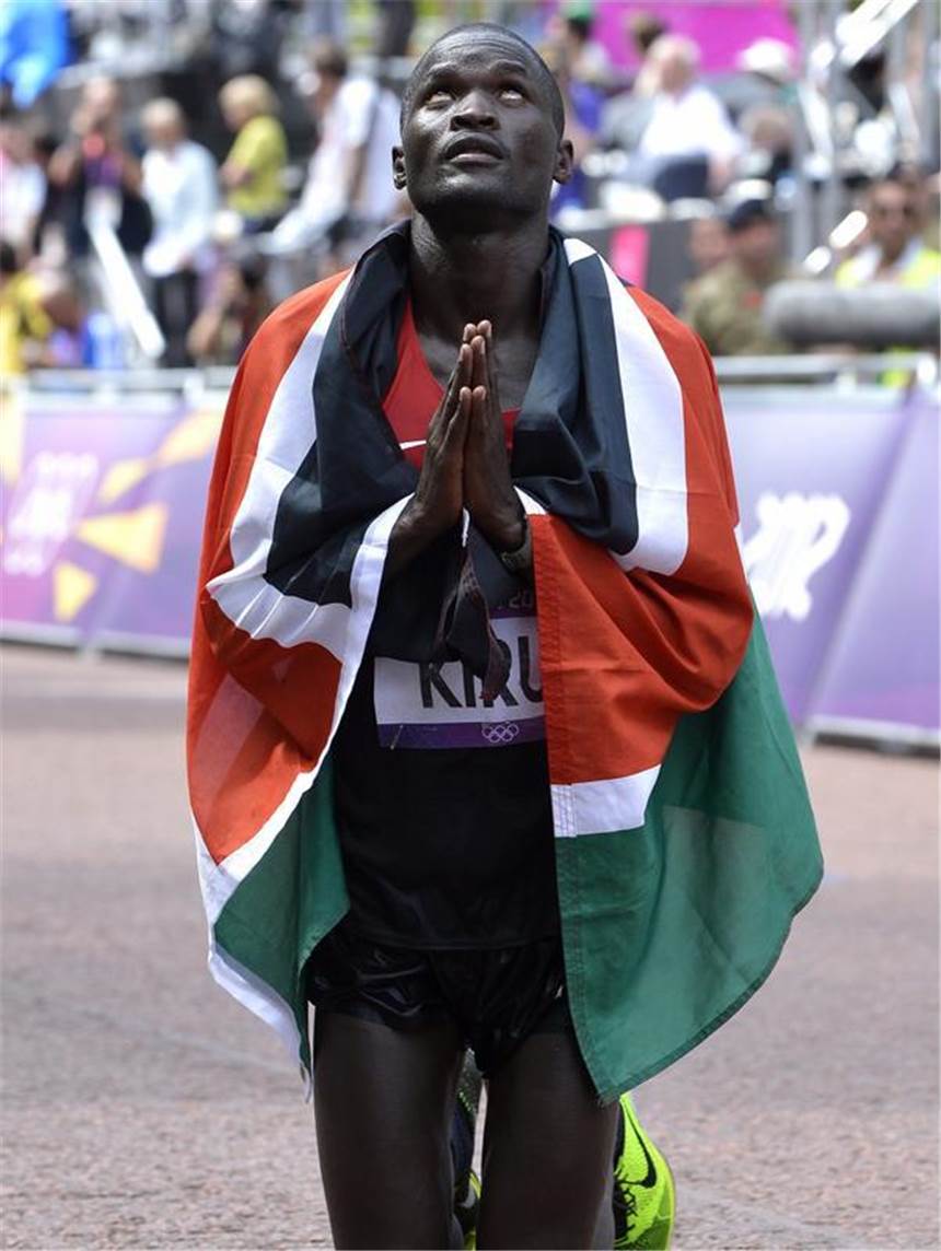 Kiprotich feiert Marathon-Gold für Uganda Abel Kirui bedankt sich mit einem Gebet für den zweiten Platz. Foto: Christophe Karaba