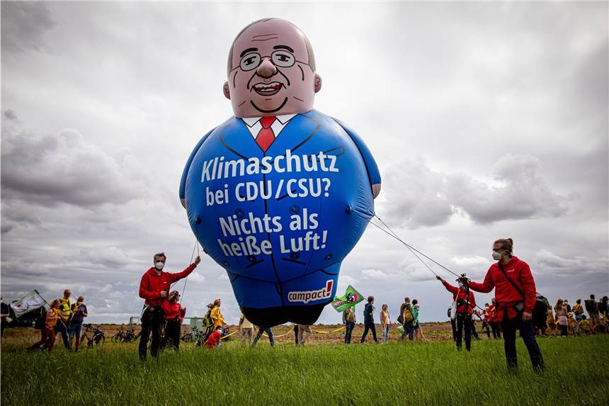Kilometerlange Menschenkette gegen Braunkohle am Tagebau Garzweiler Aktivisten halten einen Ballon, der NRW-Ministerpräsident und CDU-Kanzlerkandidat Laschet darstellen soll.