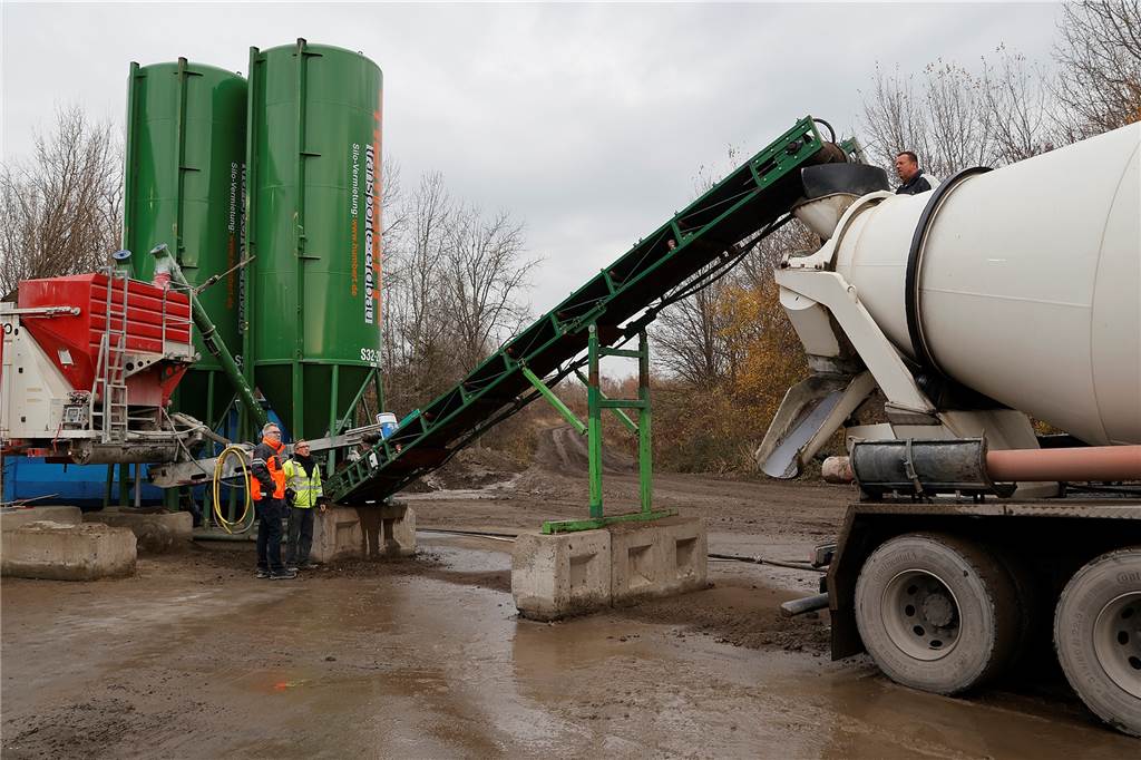An der Mühlhauser Straße läuft die selbst konstruierte Anlage, die aus Silos, Förderbändern und einem großen Mischcontainer besteht. 50 bis 60 Kubikmeter des neuartigen Flüssigbodens werden in dem Pilotprojekt täglich hergestellt.
