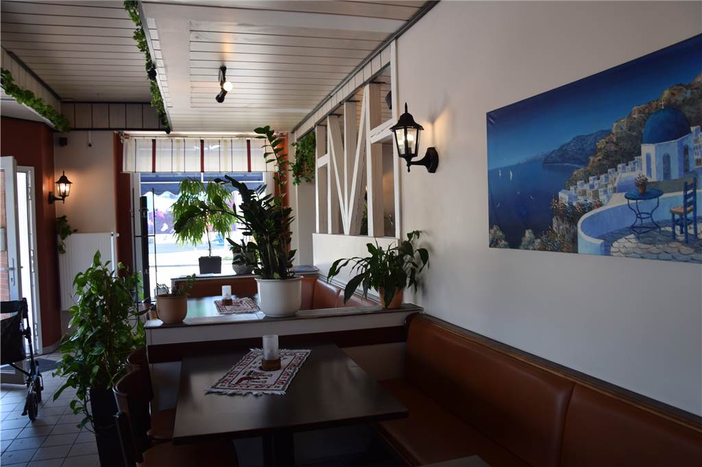 Kerkrya an der Kreisstraße: Griechische Atmosphäre mit großen Portionen für kleines Geld An der Wand hängt ein Bild der griechischen Insel Santorin.