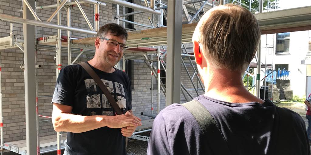Klimaschutzsiedlung in Werne: Erste Bewohner sind schon eingezogen Andreas Drohmann im Gespräch mit einem Handwerker auf der Baustelle.