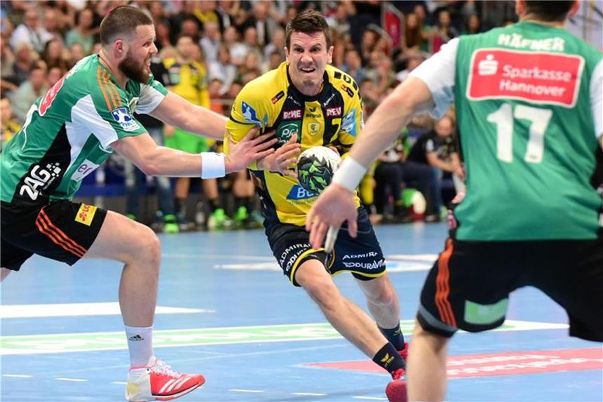 THW Kiel in Champions-League-Form - Dämpfer für Berlin Andy Schmid (M) von den Rhein-Neckar Löwen setzt sich gegen die Hannoveraner Abwehr durch. Foto: Hauke-Christian Dittrich