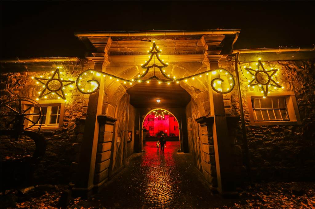 Corona-Krise: Beleuchtetes Wasserschloss lockt viele Spaziergänger an Auch das Eingangstor von Schloss Dellwig ist mit vielen Lichtern festlich geschmückt.