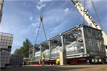 Auf dem Gelände von Rütgers in Rauxel ist eine neue große Anlage per Schiff angekommen. Sie wurde mit riesigen Autogrammen auf ein Transportfahrzeug verladen.
