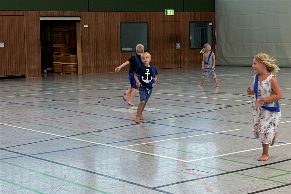 Beim Fangen toben die Kinder durch die Turnhalle.