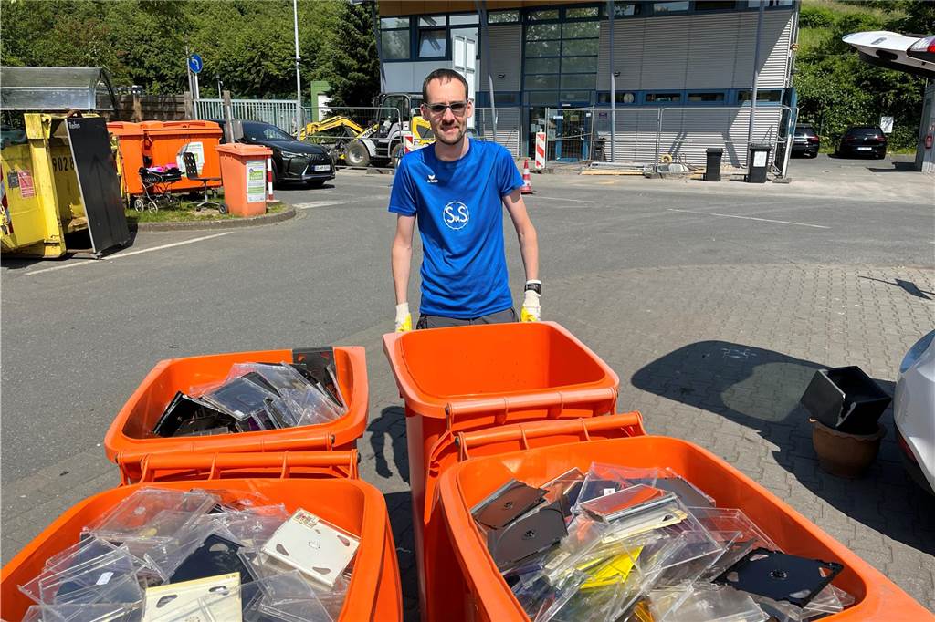 Benjamin Fritzsch mit vier von sieben Mülltonnen, die er mit CD-Hüllen gefüllt hat.