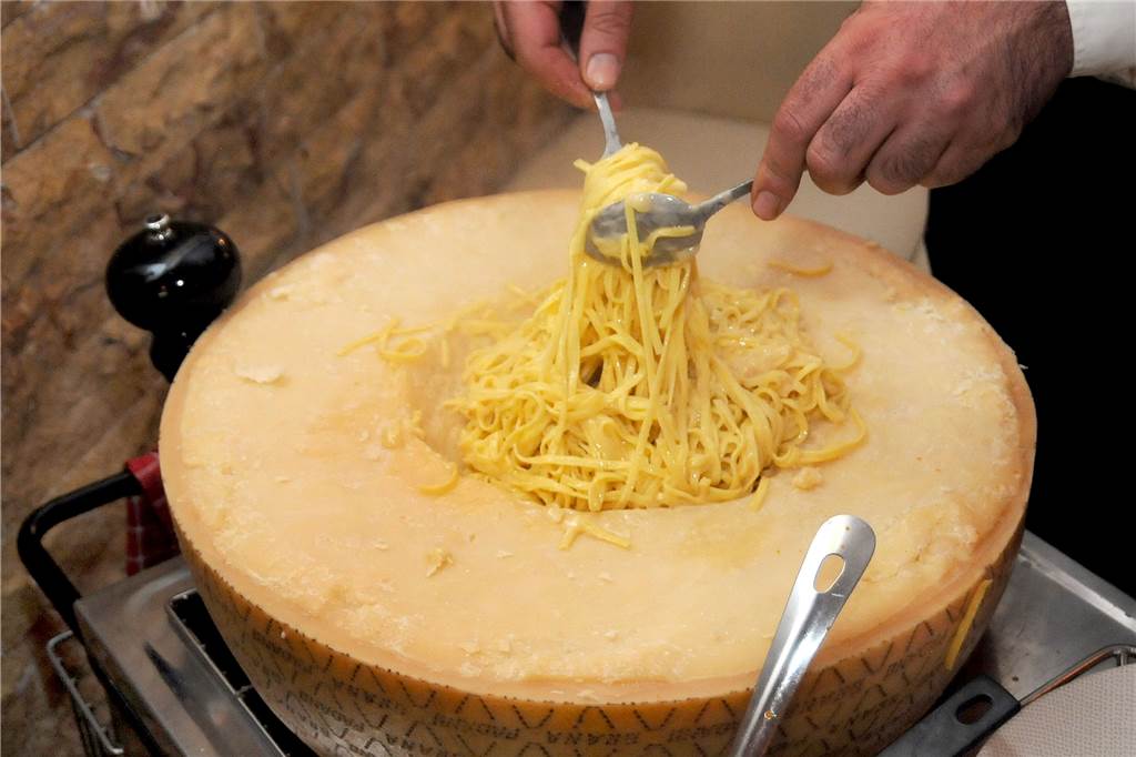 Flammen aus dem Käse-Vulkan machen Pasta zum Geschmackserlebnis Besonders cremig schmecken die Pasta, wenn sie durch den geschmolzen Käse in der Vertiefung des Käserads gedreht werden.