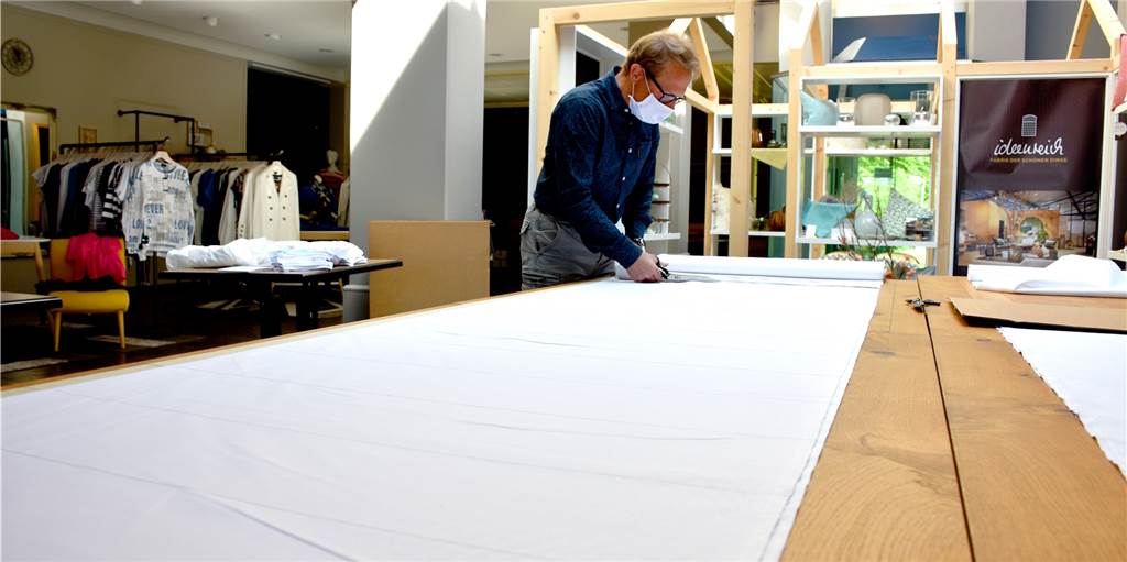 Schutzmasken statt Festtagsmode: Modehaus Hollad kämpft um die Zukunft Christoph Hollad produziert seit Montag Schutzmasken, um zumindest etwas tun zu können. Sein Bekleidungsgeschäft darf er noch nicht öffnen.