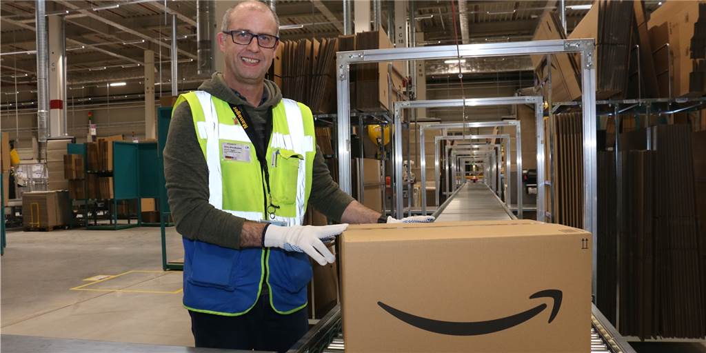 Zehn Jahre Amazon in Werne: Alles begann mit 4 Mitarbeitern und Mini-Kühlschrank John Mac Queen, der gebürtig aus Schottland kommt, arbeitet als Abteilungsleiter bei Amazon in Werne. Menschen aus gut 80 verschiedenen Nationen arbeiten im Logistikzentrum in Wahrbrink. Hier starteten vor zehn Jahren vier Mitarbeiter. Seitdem hat sich nicht nur die Mitarbeiterzahl drastisch verändert.