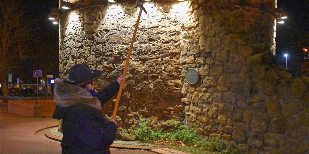 Station 9: Der Siebenteufelsturm und das Geheimnis um seinen Namen Nachtwächterin Barbara Bronzel zeigt, wie hoch die Stadtmauer in Haltern einst stand.