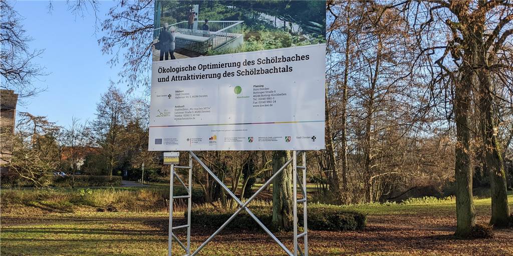 Bei einem Drei-Millionen-Umbauprojekt in Dorsten hakt es derzeit noch Das Infoschild steht bereits seit ein paar Monaten, die Schölzbachtal-Umbauarbeiten am "Wink`s Mühlen Park" am Alten Postweg werden allerdings frühestens Anfang nächsten Jahres beginnen.