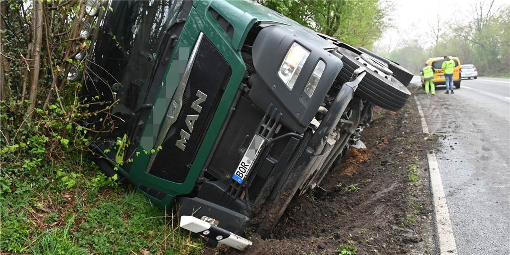 Lastwagen voller Sand kippte bei Ausweichmanöver auf die Seite LKW liegt auf der Seite im Straßengraben.