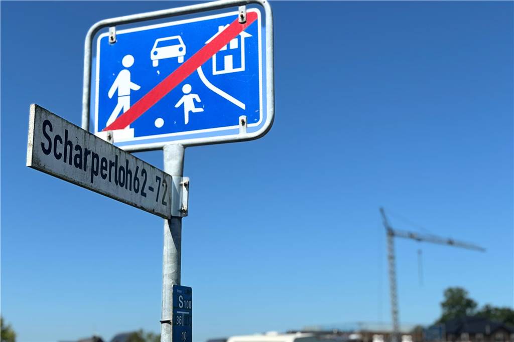 Nachfrage nach Grundstücken im Scharperloh überschaubar: 17 Bauplätze sind noch zu haben Straßenschild Scharperloh im Hintergrund Kran