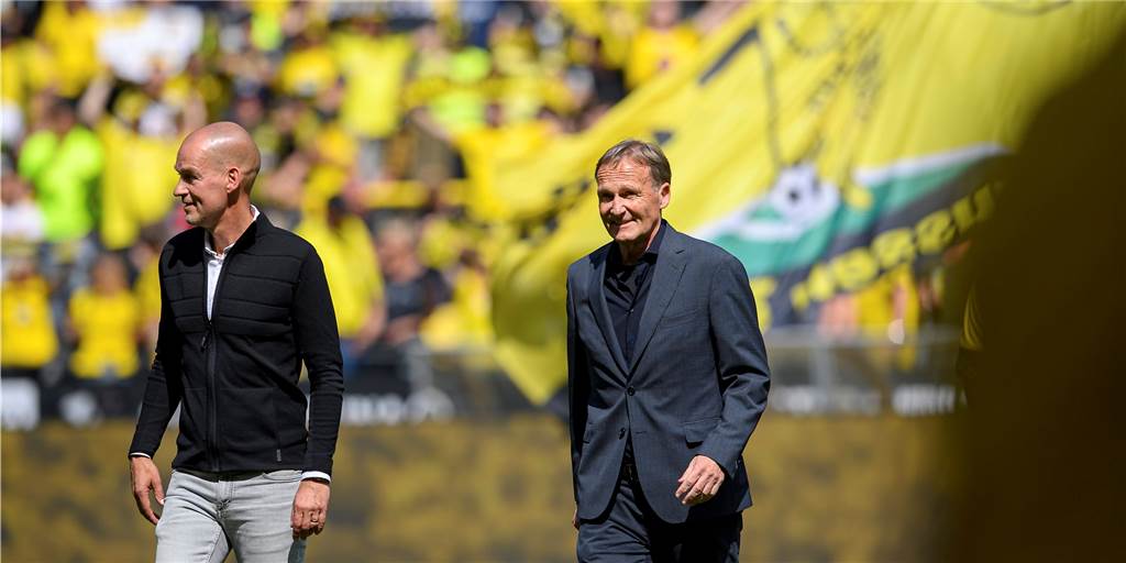 Dimitrios Kalpakidis will den BVB als Testspielgegner – Aki Watzke soll schon Bescheid wissen BVB-Geschäftsführer Carsten Cramer (l.) und Hans-Joachim Watzke laufen über den Rasen.