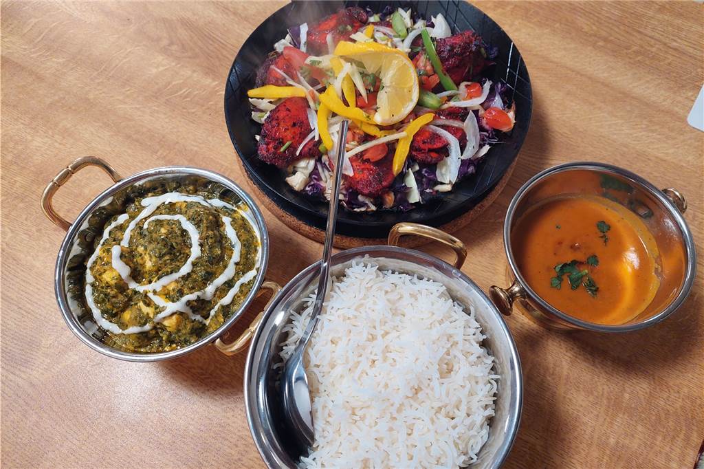 Indische Spezialitäten im Dortmunder Westen: So schmeckt das „Masala Project“ Das "Chicken Tikka" wird in der dampfenden Pfanne serviert. Das „Paneer Palak“ kommt in der kleinen Schüssel (links).