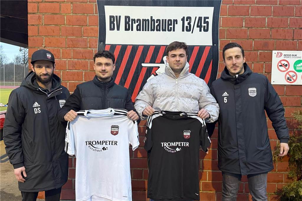 BV Brambauer verpflichtet zwei Spieler des VfB Lünen Daniel Denk und Michel Holzenthal halten Trikots in die Kamera. David Sawatzki und Dennis Köse stehen daneben.