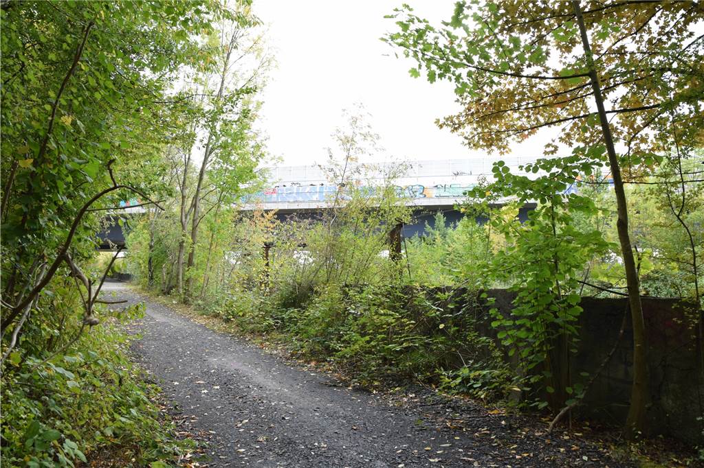 Grabsteine unter der Schnettkerbrücke in Dortmund geben Rätsel auf Der ehemalige Steinmetzbetrieb in Dortmund liegt an einem Spazierweg. Von diesem aus ist die Schnettkerbrücke gut zu sehen.