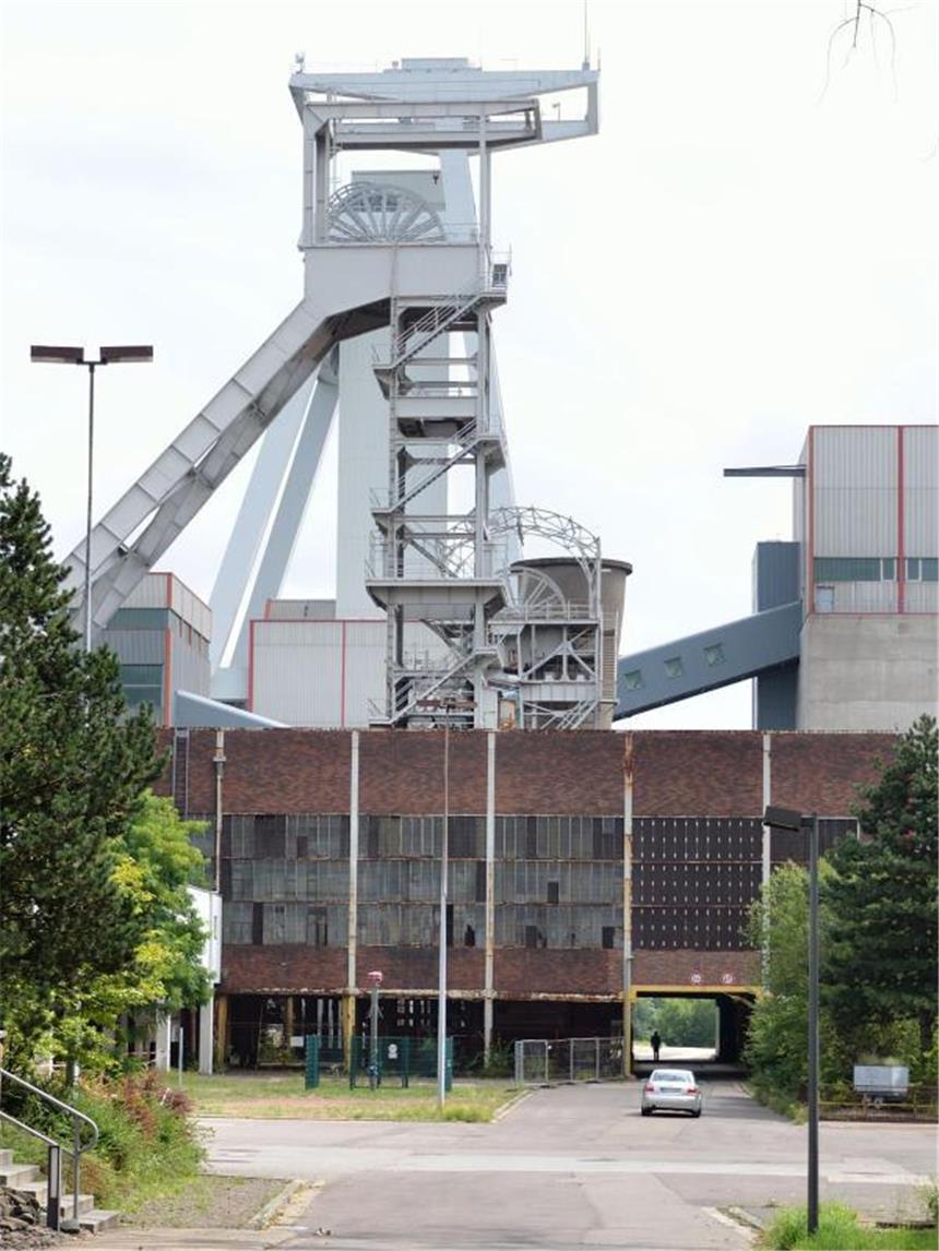 Unter Tage: Reise durch die Bergbau-Geschichte an der Saar Der Förderturm «Weißer Riese» beim «Zukunftsort» Göttelborn ist 90 Meter hoch. Besucher können die Gegend um das Abbaugebiet auf einem Rundweg erwandern. Foto: Jörg Fischer