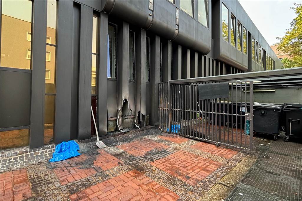 Brennende Müllcontainer in der Schmiedingstraße Die Hauswand des Bürogebäudes hat nach dem Brand ein Loch.