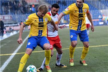 Die beiden Braunschweiger Jan Hochscheidt (l) und Ken Reichel nehmen Regensburgs Albion Vrenezi (M) in die Zange. Foto: Peter Steffen
