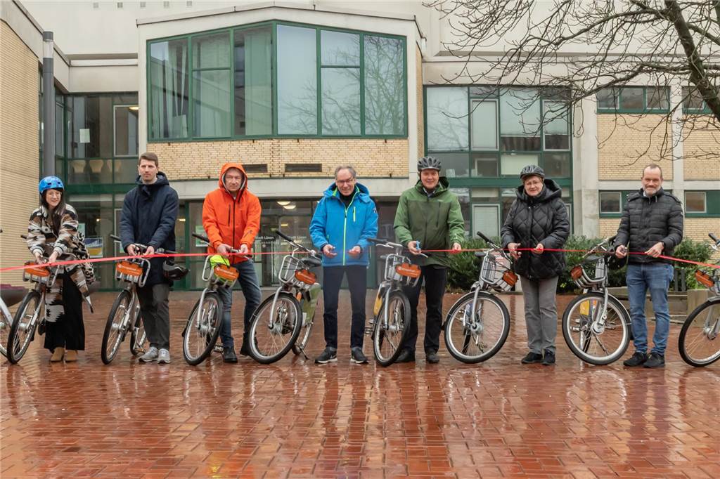 Bike-Sharing gestartet: Leih-Fahrräder an 21 Standorten zu finden Sieben Projektbeteiligte schneiden die rote Schnur zur Eröffnung durch.