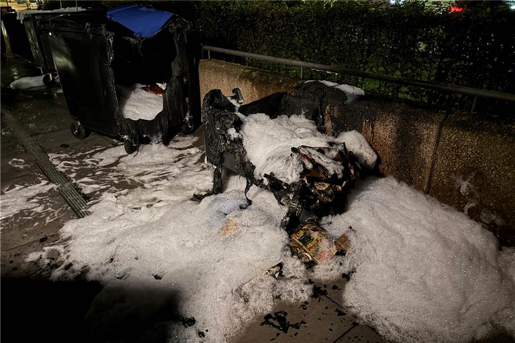 Schon wieder Mülltonnen in der Innenstadt angezündet: Polizei sucht Brandstifter Die Feuerwehr hat eine abgebrannte Mülltonne mit Löschschaum bedeckt.