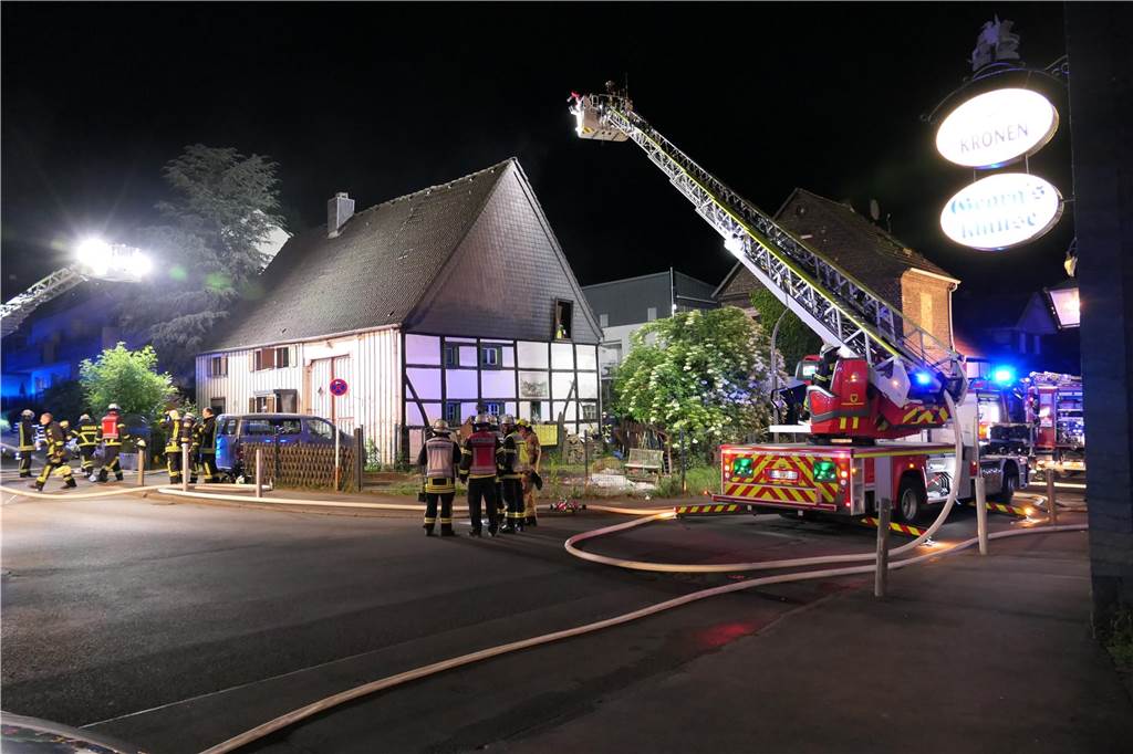 Vor dem Fachwerkhaus in der Ruinenstraße stehen Feuerwehrleute und Einsatzfahrzeuge.