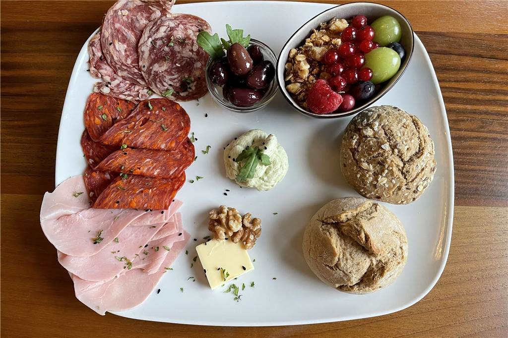 Das „450 Degrees“ im Café-Check: Restaurant bietet auch Frühstück an Auf einem Tisch im Restaurant "450 Degrees" in Dortmund-Mengede steht eine Frühstücksplatte, unter anderem mit Brötchen, Oliven und Schinken.