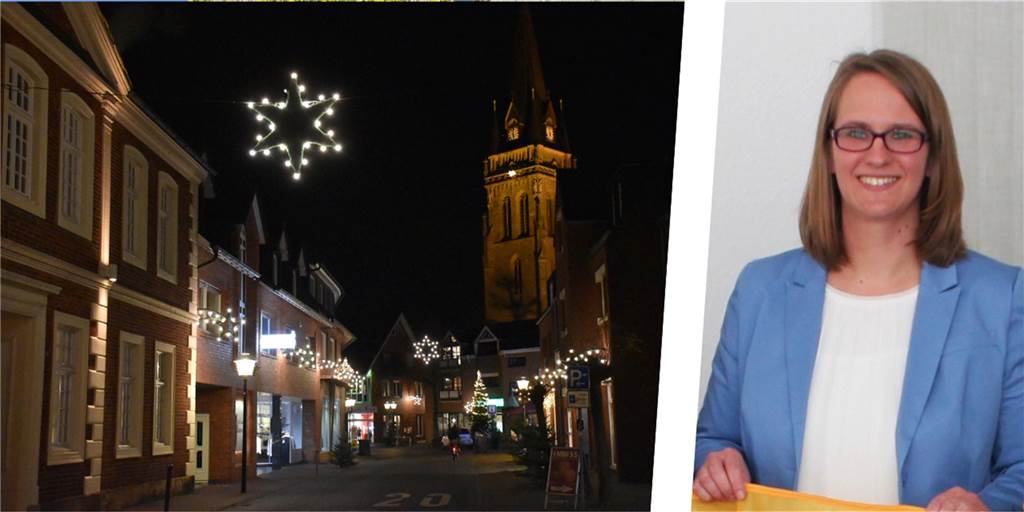 Weihnachtsbeleuchtung in einer Straße und eine Frau