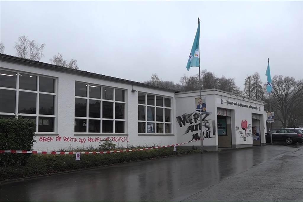 Merz wird in Menden von linksradikalen Parolen empfangen Schmierereien gegen den CDU-Spitzenkandidaten am Gebäude der Schützenhalle Hüingsen in Menden.