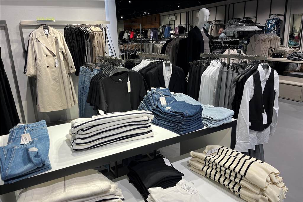 Secilya Yüce zeigt neuen S1-Laden in Mercaden nach dem Umzug Pullover und Hosen liegen im S1 in den Mercaden in Dorsten auf einem Tisch.