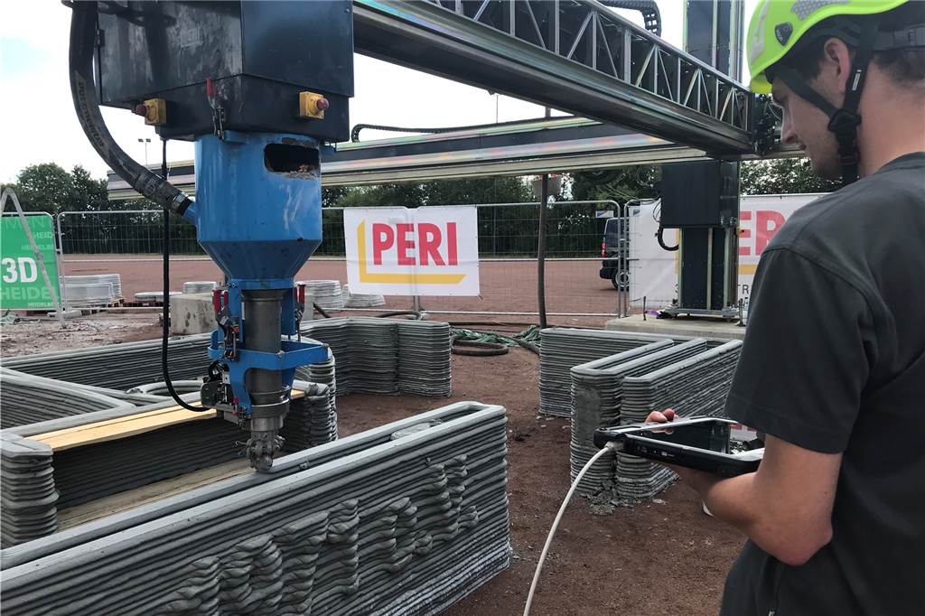 In Capelle wird ein Haus gedruckt – mit viel Potenzial für das Baugewerbe Ein Maschinenbauer von Peri verfolgt die Fahrt des Druckers.