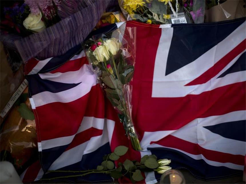 Polizei nach Manchester-Anschlag: Abedi hatte Hintermänner Ein Union Jack, Blumen und Kerzen liegen in Manchester nach einer Gedenkfeier auf dem Albert Square. Foto: Emilio Morenatti
