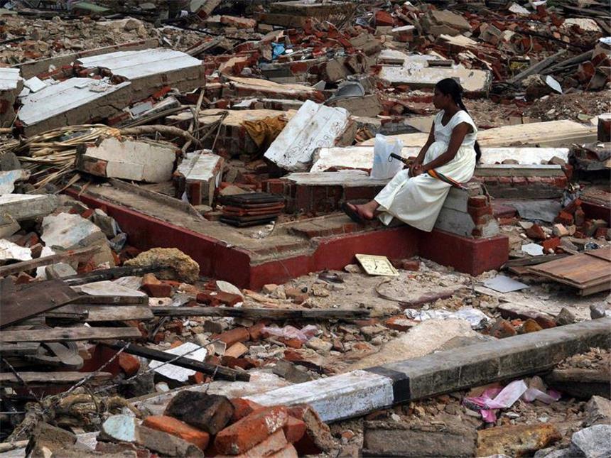Thailand und Indonesien gedenken der Tsunami-Opfer Eine Frau sitzt auf den Trümmern ihres Hauses in Galle im Süden Sri Lankas. Foto: Ma Pushpa Kumara/Archiv