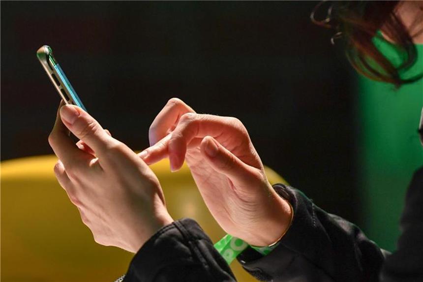 Vom Sofa aus: Gründer können Gewerbe künftig online anmelden Eine Frau tippt auf ihrem Smartphone. Foto: Jens Kalaene/Archiv