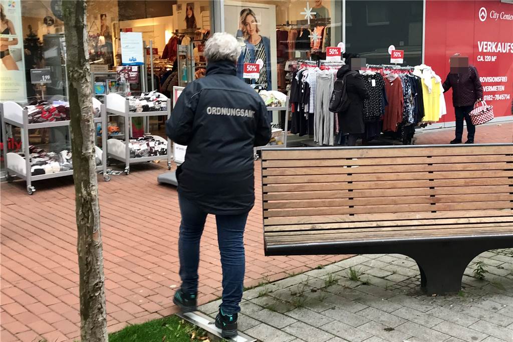 Der große Check: Castrop-Rauxeler tragen Maske – aber viele machen’s falsch Eine Mitarbeiterin des Ordnungsamtes auf dem Weg zu einer Frau, die keine Maske trägt (hinten r.).