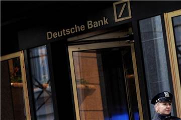 Eine Polizistin steht am Gebäude der Deutschen Bank in der Wall Street. Foto: Justin Lane/EPA/Illustration
