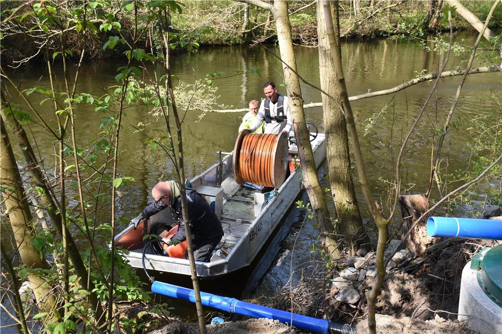 Zwischenstever wird im Kampf gegen das Fischsterben dauerbelüftet Fachleute und Mitarbeiter von Gelsenwasser schlossen den Schlauch an die Kompressor-Zuleitung an.