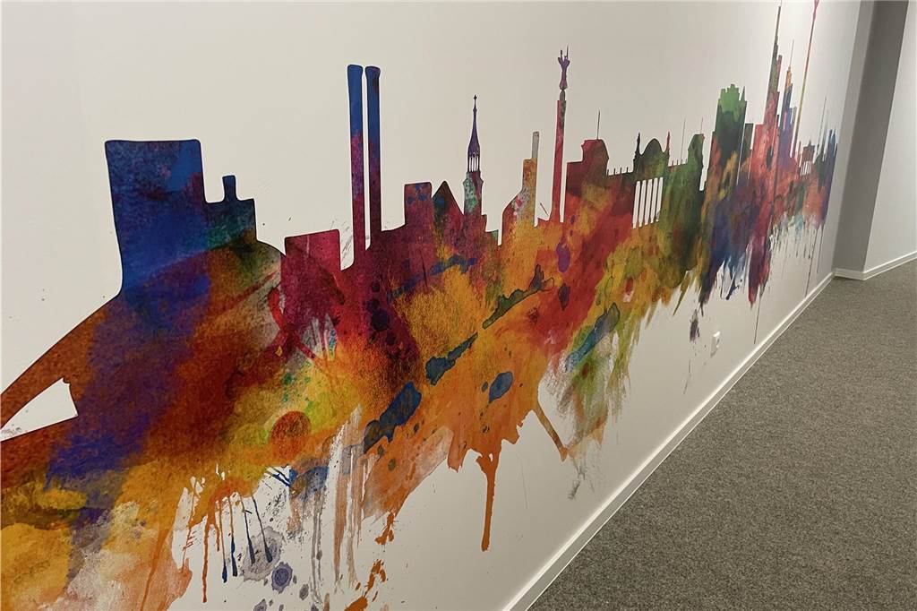 Farbtupfer: Auf jeder Etage sind die Wände mit der Skyline einer Stadt tapeziert worden.
