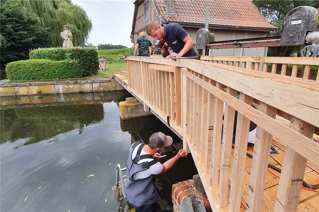 Zwei Tonnen Holz: Brücke der historischen Wassermühle wird runderneuert Für die Sanierungsarbeiten mussten die Mitarbeiter der Firma Hesuing sogar auf einer Leiter in die Dinkel steigen.