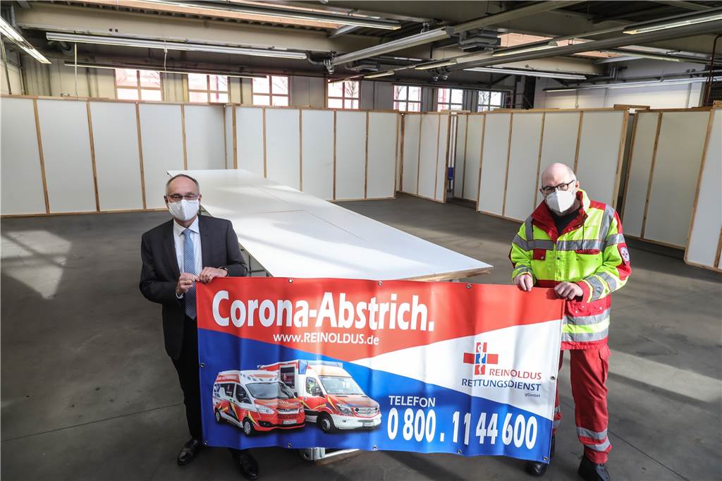 So sieht es in Dortmunds neuem Corona-Testzentrum mit „Drive In“ aus Gesundheitsamtsleiter Dr. Frank Renken (l.) und Peter Hill vom Reinoldus Rettungsdienst in der früheren Auto-Werkstatt, in der jetzt Abstrichräume eingerichtet sind.