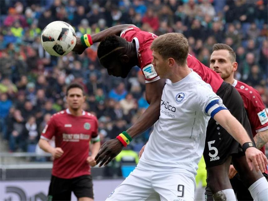Hannovers Salif Sané (l) und Bielefelds Fabian Klos kämpfen um den Ball. Foto: Peter Steffen