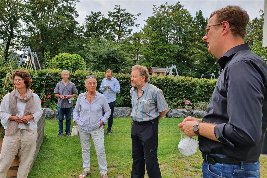 Im Garten haben einige Bewohner dem Mitglied des Bundestages Oliver Kaczmarek (r.) davon berichtet, wie der Alltag in einem Mehrgenerationenhaus abläuft.