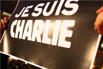 Im Gedenken an die Opfer der Pariser Anschläge hält ein Mann im Januar 2015 ein Schild mit dem Slogan "Je Suis Charlie" (Ich bin Charlie) in die Höhe. Foto: Fred Scheiber/Archiv