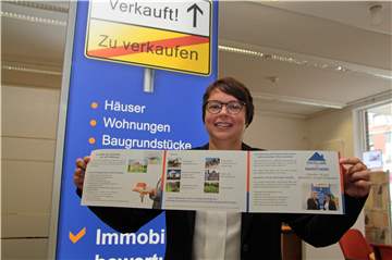 Immobilienberaterin Sandra Pippel mit einem Prospekt ihrer Bank. Schon seit Jahren übersteigt die Nachfrage das Angebot an Häusern, Grundstücken und Eigentumswohnungen.