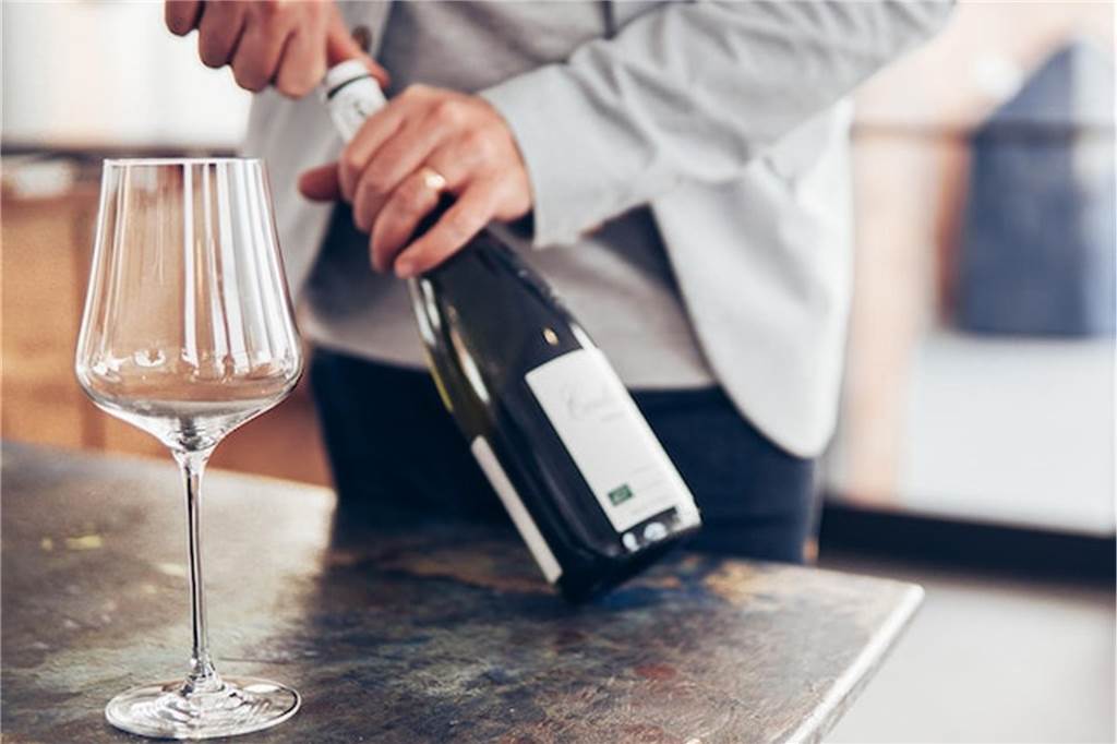 Weingenuss in NRW: Hier kommen Vino-Fans auf ihre Kosten mann entkorkt einen wein