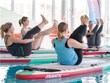 In einem Kurs demonstriert die Initiative "SUP Teamsport", dass auf dem SUP-Board auch Yoga-Übungen möglich sind. Foto: Daniel Bockwoldt/dpa