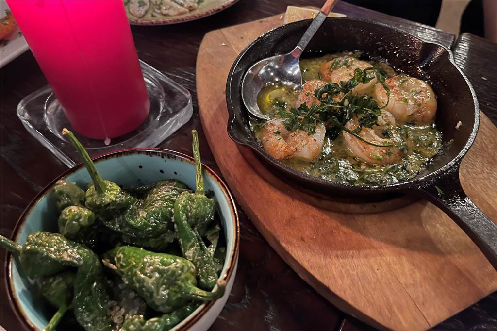 Auf der Jagd nach kleinen Köstlichkeiten – Tapasbar „Chuzo“ im Check In Weißwein, Öl und Knoblauch eingelegte Gambas und ein Tapasklassiker Pimientos.