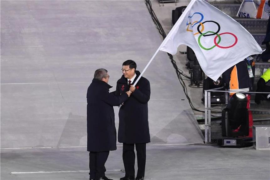 Ende in Pyeongchang - Startschuss für Tokio 2020 IOC-Präsident Thomas Bach (l) übergibt die olympische Flagge an Pekings Bürgermeister Chen Jining. Foto: Hendrik Schmidt